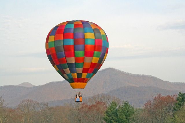 Colorful hot air balloon in the sky with mountains as a backdrop