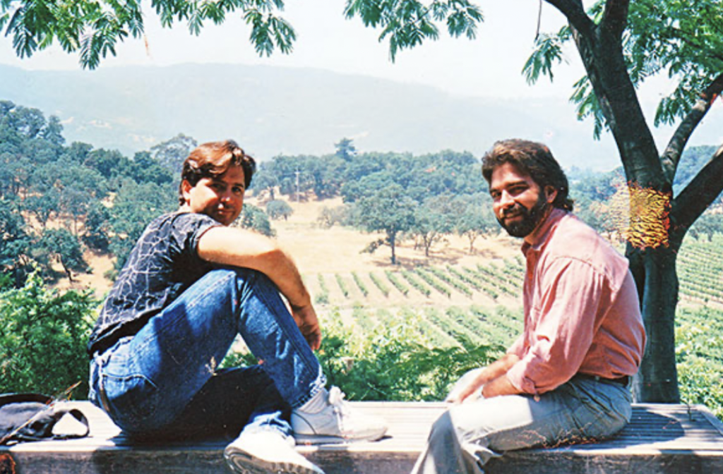 Two men sitting in a vineyard