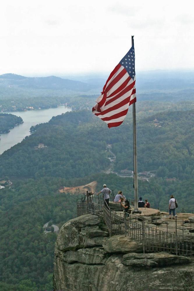 Flag blowing in the wind onto of Chimney Rock State Park